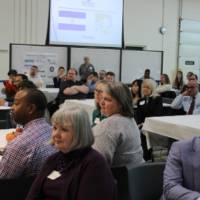 Participants listen to presenters